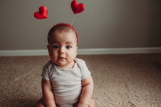 baby sitting up wearing heat antennae 