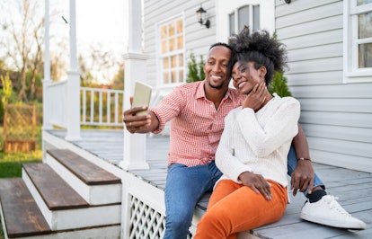 A happy couple snap a selfie on a spring afternoon on their back porch.
