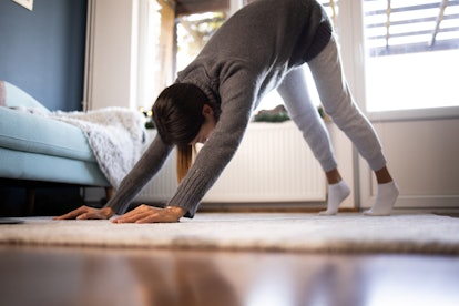 A woman in a downward facing dog. Yoga pros share their morning routines for yoga flow ideas.