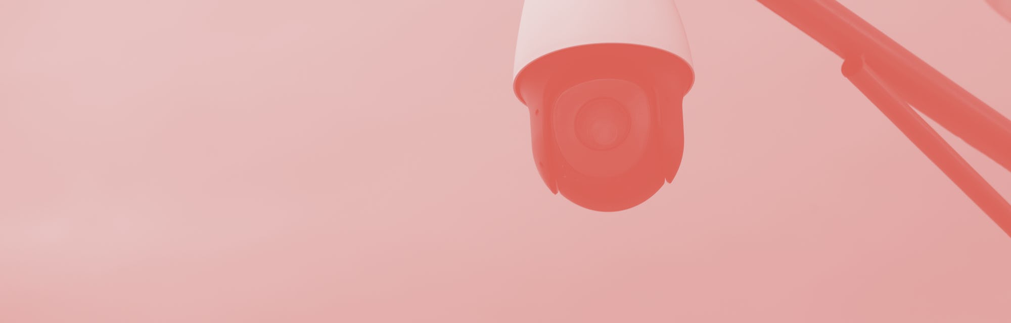 Security camera below a blue sky.