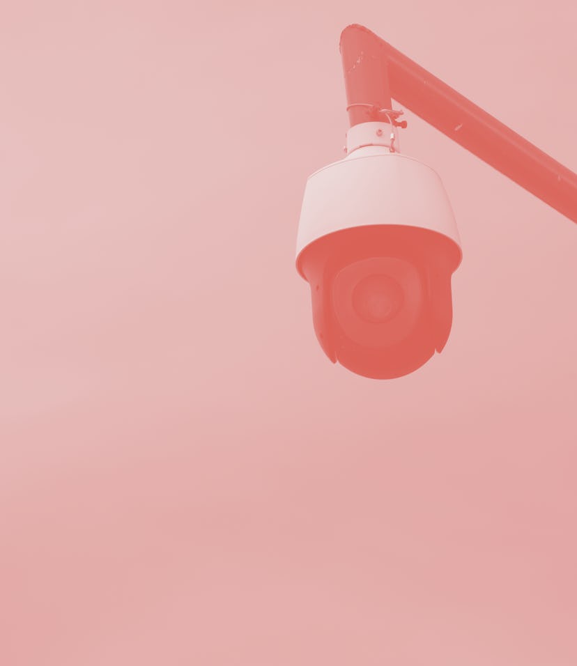 Security camera below a blue sky.