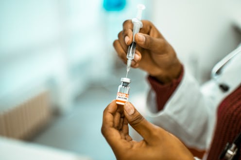 A nurse gets a dose of COVID-19 vaccine. Doctors explain how to get the covid vaccine without insura...