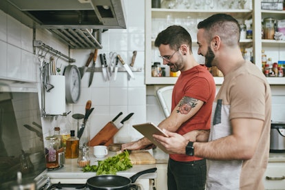 Two men in a kitchen cooking together to make Valentine's Day feel romantic at home