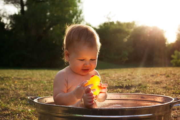 baby boy taking bath outside. the photo accompanies the name Dalis in an article about aquarius baby...