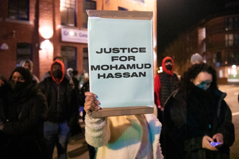 A person holds a sign at the protest for Mohamud Hassan.