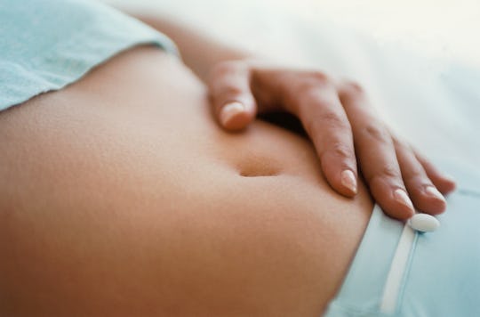 woman touching her stomach