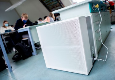 air filters in an office with workers sitting at desks