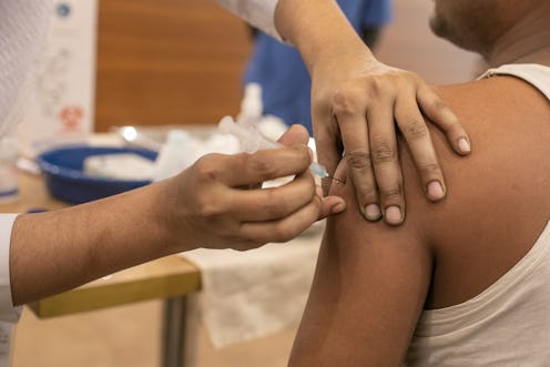 A person receives a vaccine shot in the arm. Since you need two doses of the COVID vaccine, you migh...