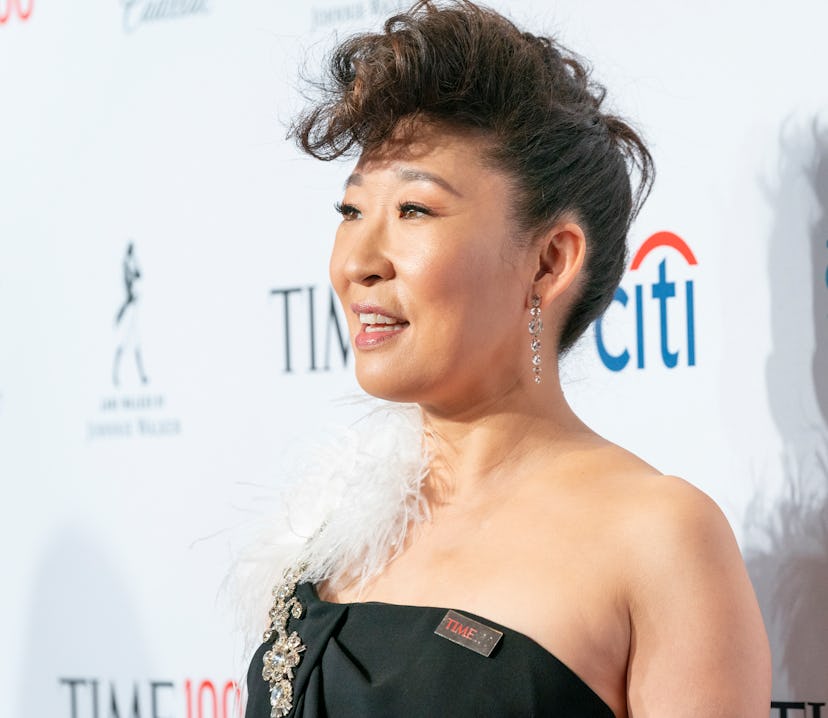 Actress Sandra Oh styles her curly bangs in an edgy mohawk updo