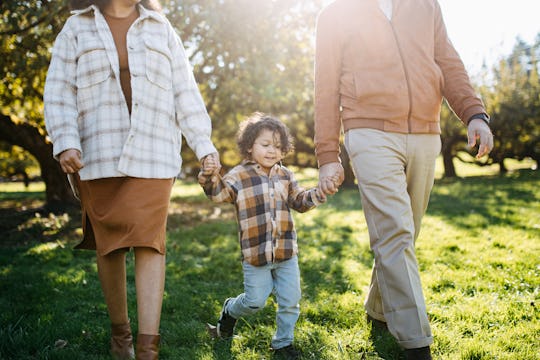 kid walking with parents