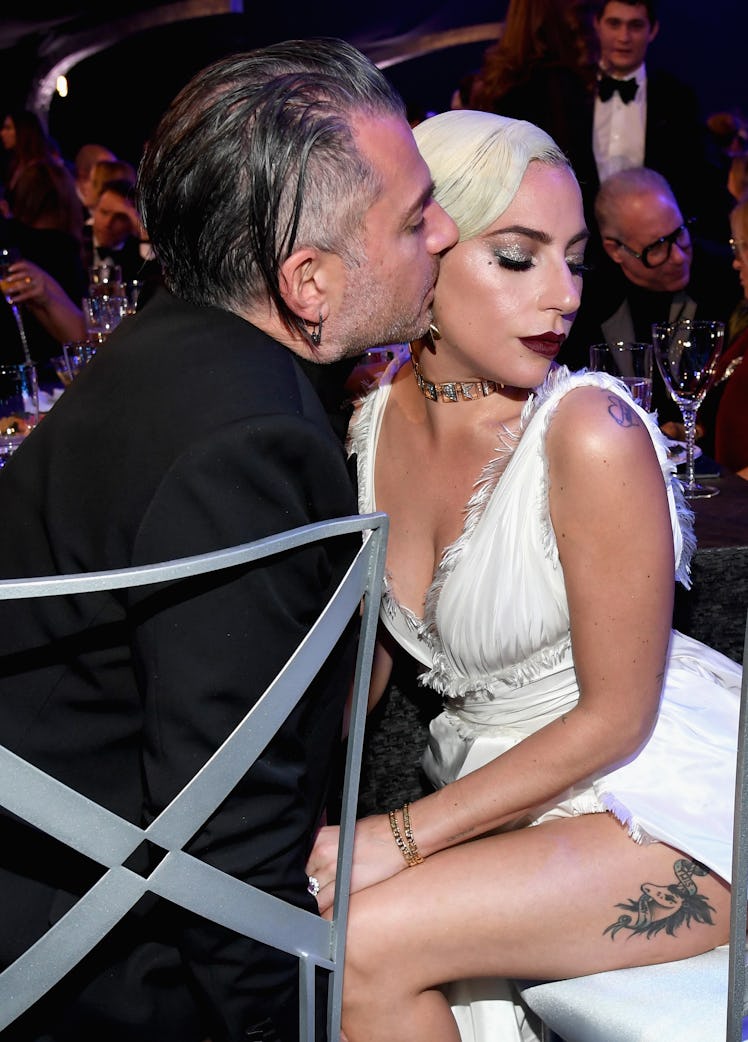 Christian Carino kisses Lady Gaga on the cheek.