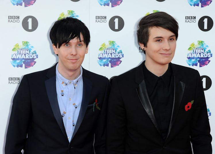 YouTubers Phil Lester and Dan Howell wear black suits on the Teen Awards red carpet.