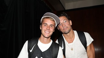 Justin Bieber in a black jersey with a white t-shirt underneath and Pastor Carl Lentz in a plain whi...