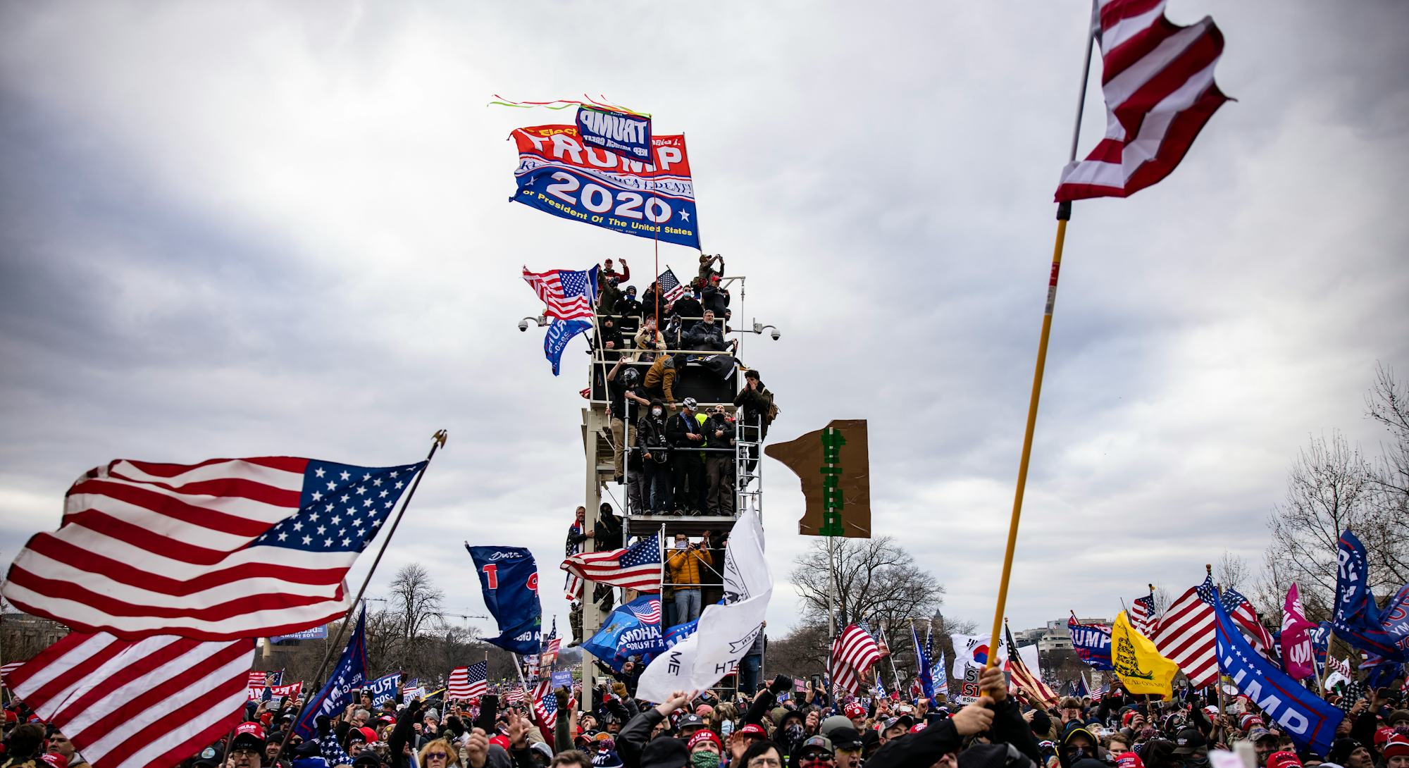 Rioters hold up a trump 2020 flag. Photos of Wednesday Jan 6 Capitol Building insurrection.