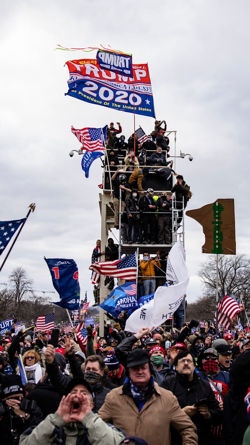 Rioters hold up a trump 2020 flag. Photos of Wednesday Jan 6 Capitol Building insurrection.