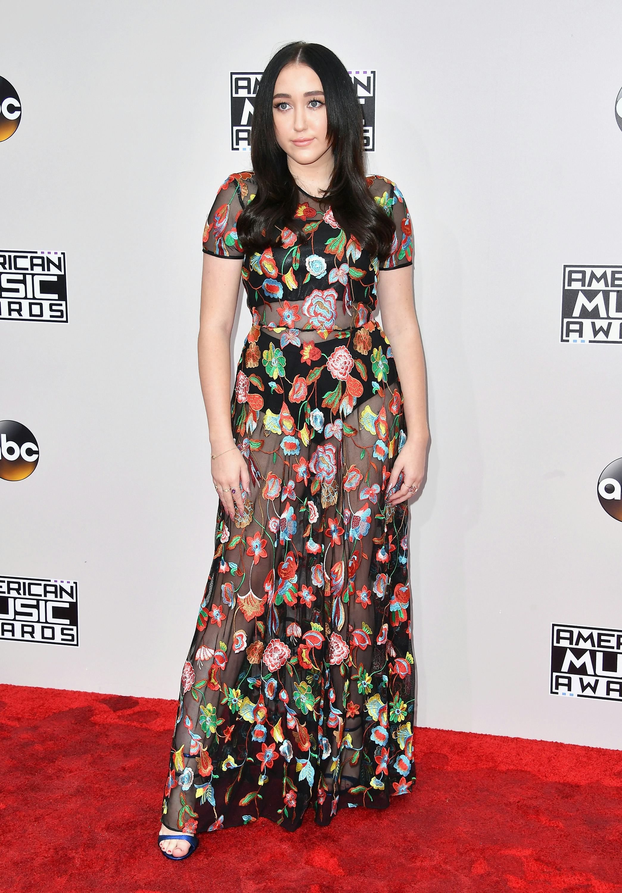 Noah Cyrus in a long short-sleeved black floral dress