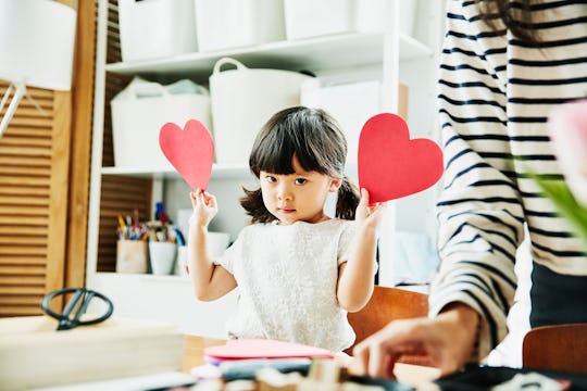 little girl making valentine's day crafts