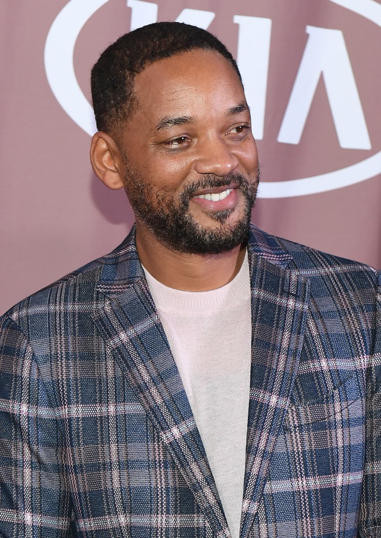 Will Smith smiles on the red carpet.