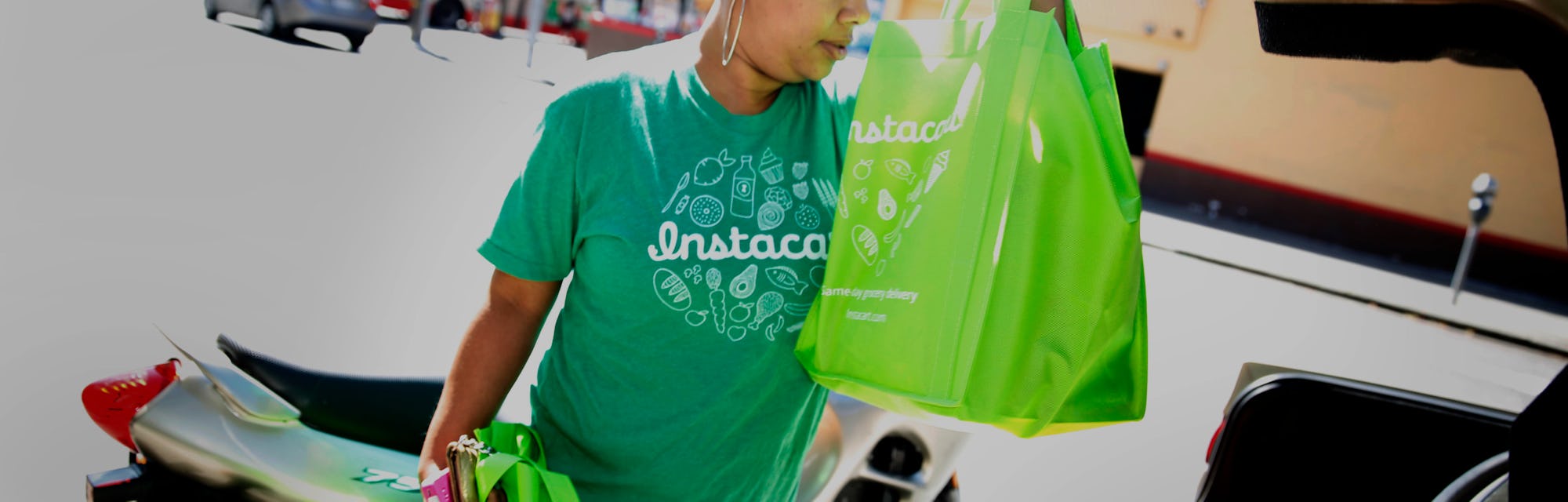 Instacart personal shopper, Tammara Dozier, places a customer's order into her car for delivery on T...