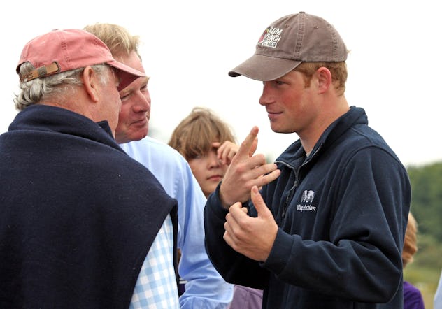Prince Harry wears a half zip sweater.