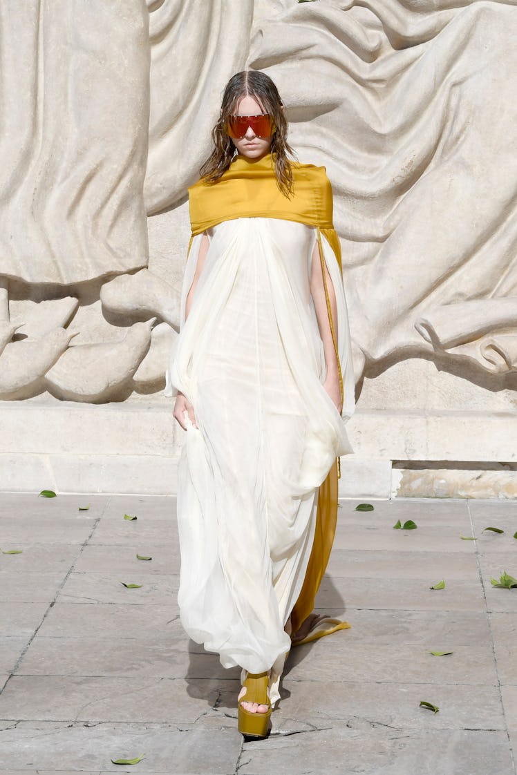 A model walking in a white dress at the Rick Owens Womenswear Spring/Summer 2022 show