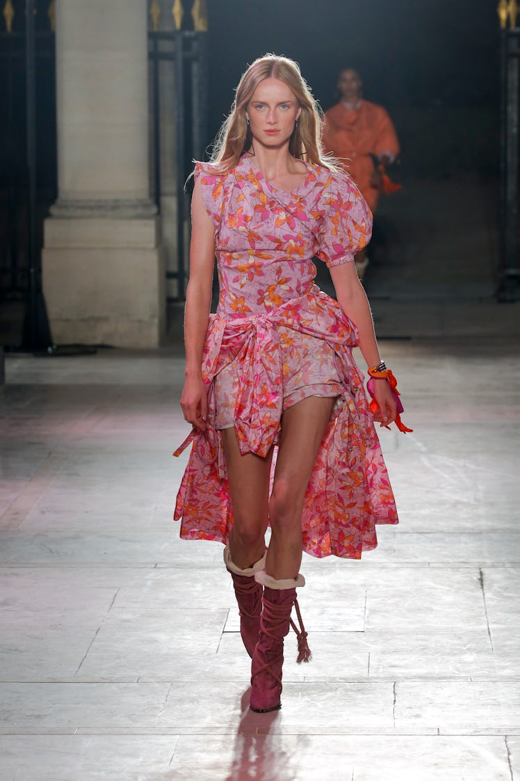 A model walking in a pink floral dress at the Isabel Marant Ready to Wear Spring/Summer 2022 fashion...