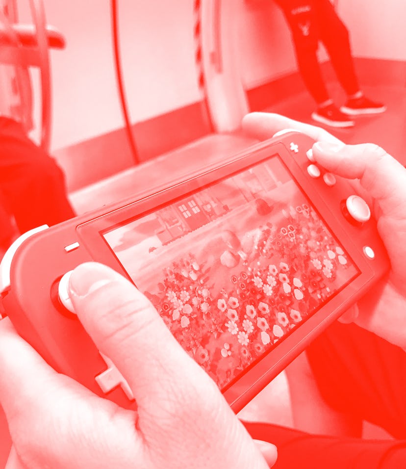 BEIJING, CHINA - JUNE 14: A passenger uses a Nintendo Switch to play video game 'Animal Crossing: Ne...