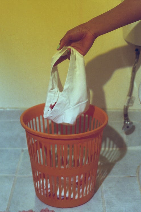 A woman puts stained underwear in the wastebin. How often to change tampon? An OB-GYN explains how o...