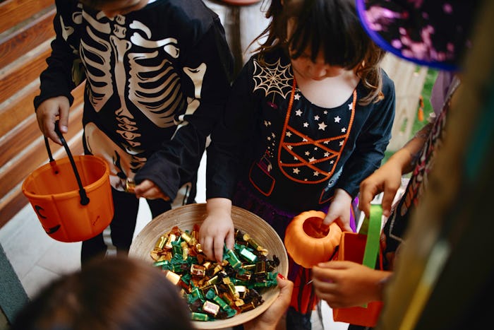 Children play at a Halloween party in the garden, backyard. Halloween concept