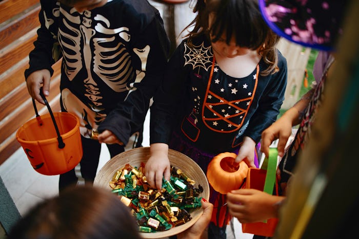 Children play at a Halloween party in the garden, backyard. Halloween concept