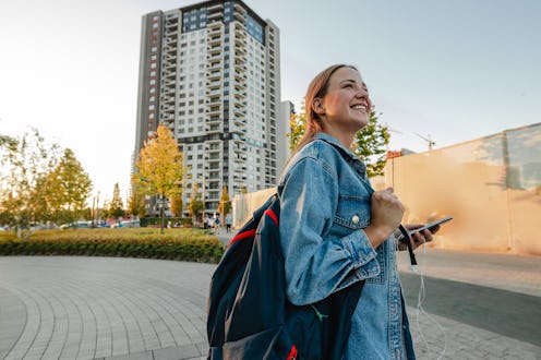 Young blond hair woman on the street using a mobile phone for communication