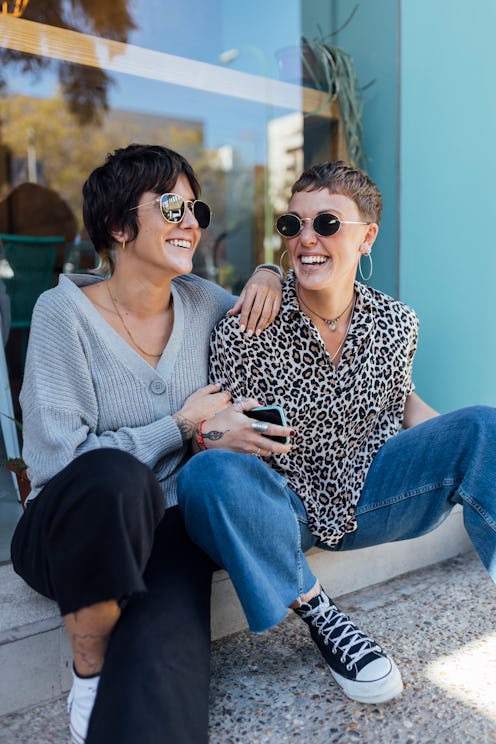Two friends hang out on a step. Experts share what to say to someone who's just come out and support...