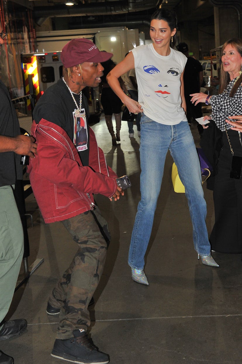 Travis Scott and Kendall Jenner attend a basketball game.