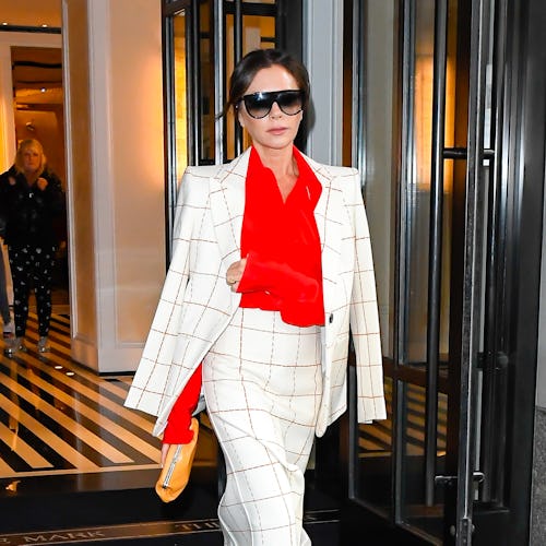 Victoria Beckham wearing a colorful red blouse. 