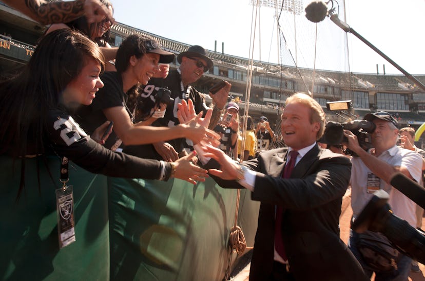 Former Oakland Raiders head coach Jon Gruden, right, now an ESPN broadcaster, greets denizens of the...