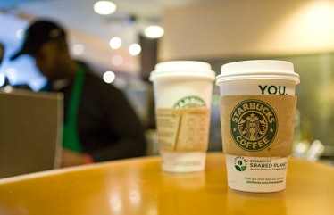 A Starbucks barista preparing mixed coffee drinks at a Starbucks Coffee Shop