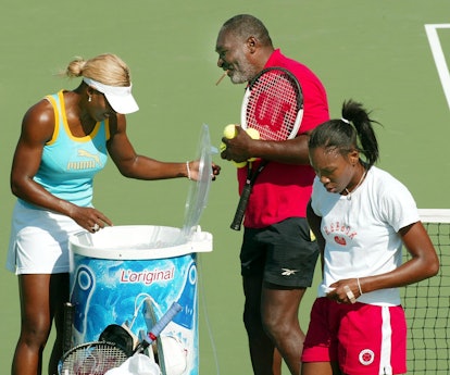 Number one seed Serena Williams (L) and her sister number two seed Venus Williams (R) take a break f...