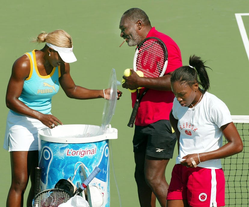 Number one seed Serena Williams (L) and her sister number two seed Venus Williams (R) take a break f...