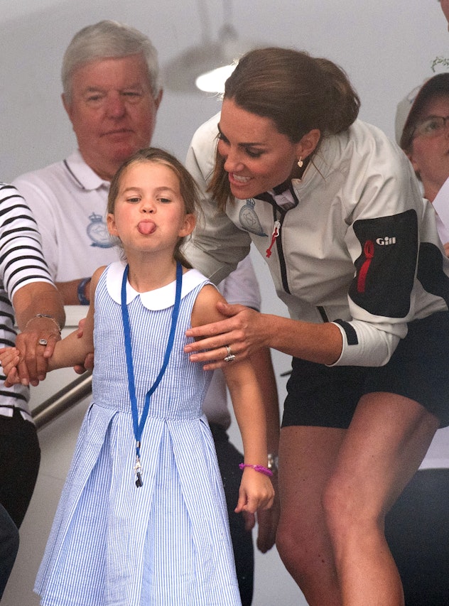 Princess Charlotte sticks out her tongue.