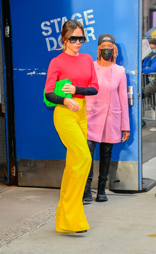 Victoria Beckham wearing a brightly colored outfit in New York City. 