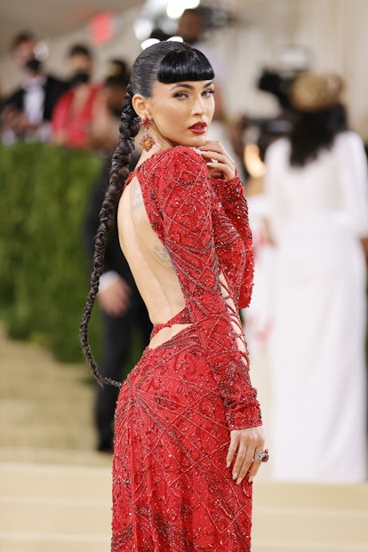 At the 2021 Met Gala, Megan Fox wore a long high ponytail braid with chords intertwined.