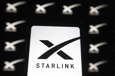 UKRAINE - 2021/02/21: In this photo illustration a Starlink logo of a satellite internet constellati...