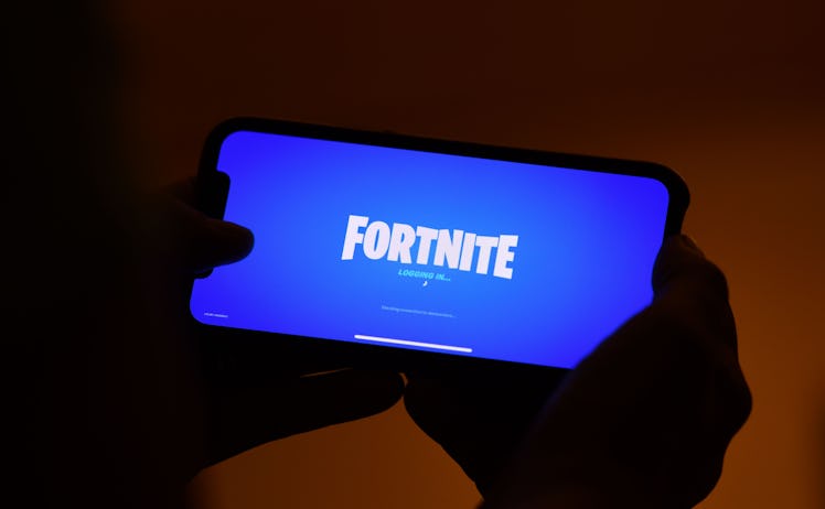 This illustration picture shows a person logging into Epic Games' Fortnite on their smartphone in Lo...