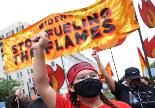 WASHINGTON, DC - OCTOBER 12: Climate protesters march to the White House on October 12, 2021 in Wash...