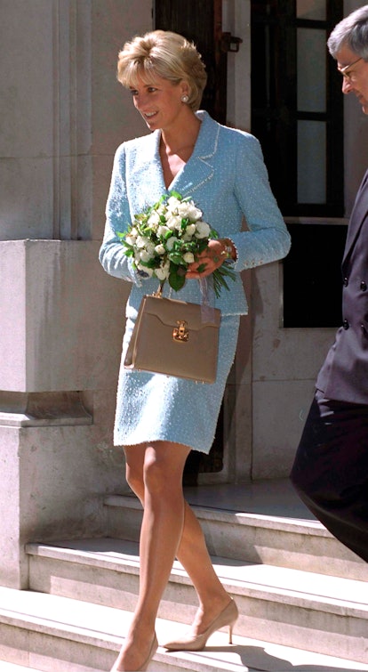 Princess Diana carries a beige Lana Marks top handle bag.
