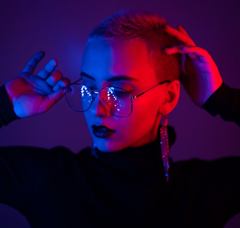 Woman in neon light, embracing the spiritual meaning of the November 2021 new moon in Scorpio
