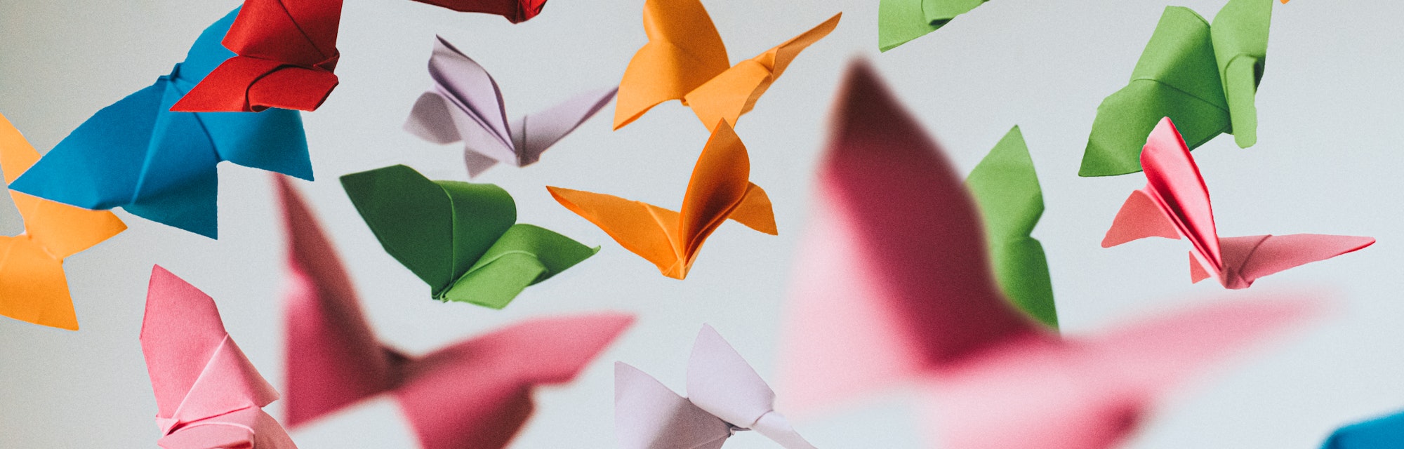 Falling coloured origami paper butterflies. Conceptual.