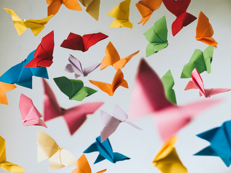 Falling coloured origami paper butterflies. Conceptual.