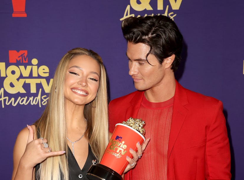 Madelyn Cline and Chase Stokes, whose body language proves that they might've broken up, pose with a...