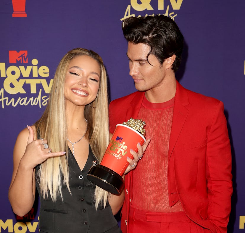 Madelyn Cline and Chase Stokes, whose body language proves that they might've broken up, pose with a...